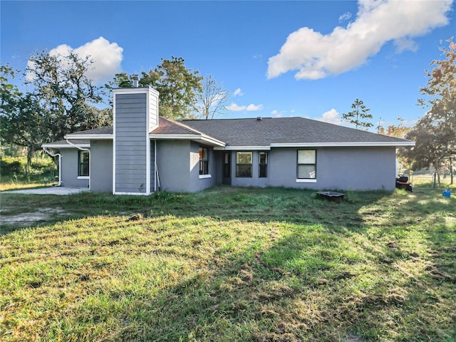 rear view of property with a lawn