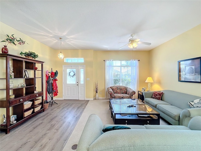 living room with ceiling fan and light hardwood / wood-style floors