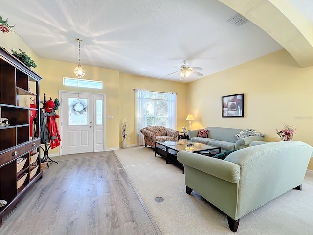 living room featuring ceiling fan and light wood-type flooring