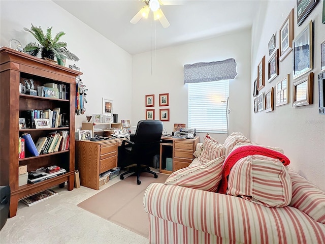 carpeted office space featuring ceiling fan