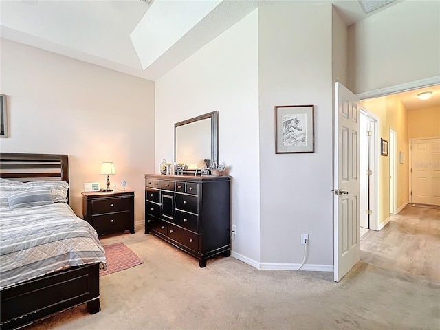 carpeted bedroom with high vaulted ceiling