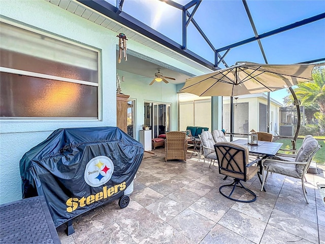 view of patio / terrace with ceiling fan and a lanai