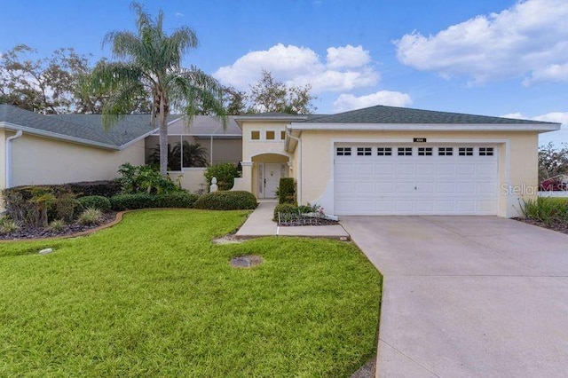 view of front facade with a front yard and a garage