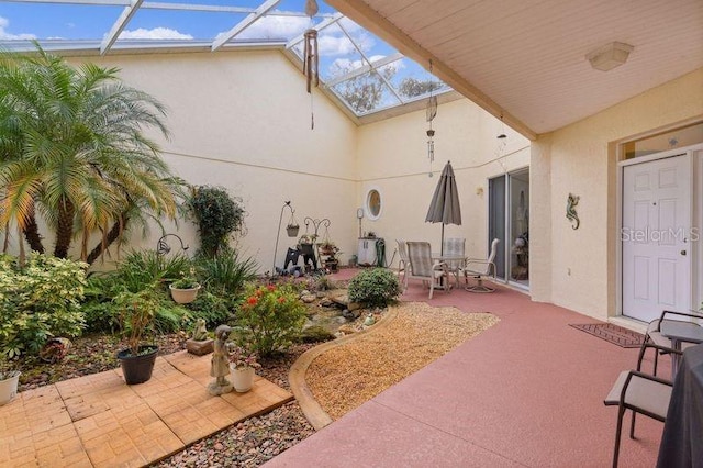 view of patio with glass enclosure