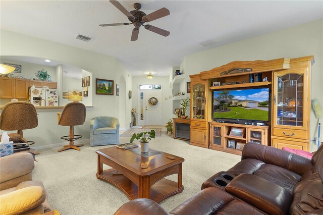 carpeted living room featuring ceiling fan