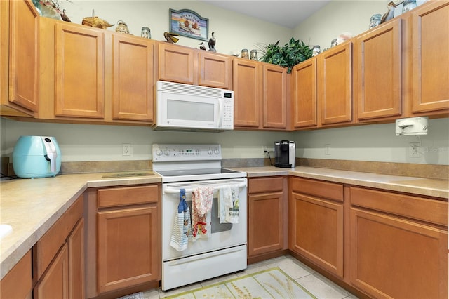 kitchen featuring white appliances and light tile patterned floors