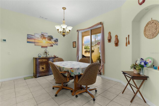 tiled dining area with an inviting chandelier