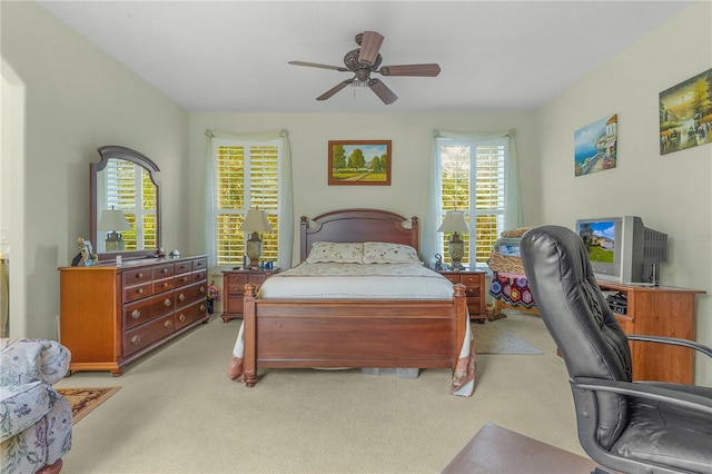 bedroom with light carpet and ceiling fan