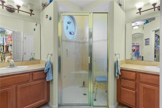 bathroom featuring vanity and an enclosed shower