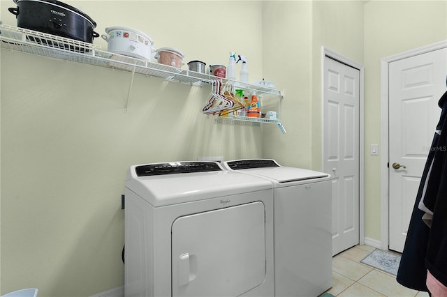 washroom with light tile patterned floors and separate washer and dryer