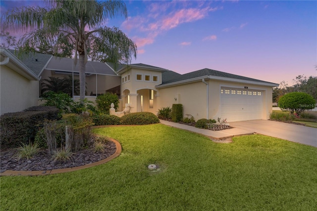 view of front of home with a yard, a garage, and a lanai