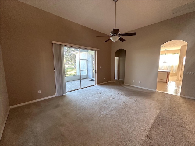 spare room featuring ceiling fan, plenty of natural light, carpet floors, and high vaulted ceiling