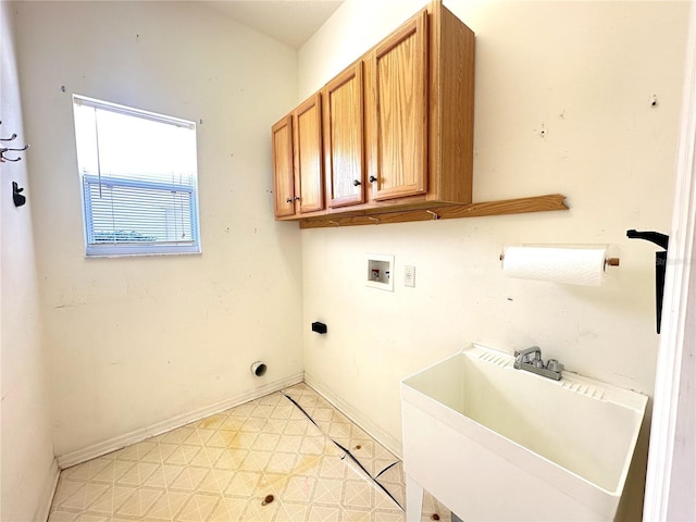 washroom featuring washer hookup, cabinets, and sink