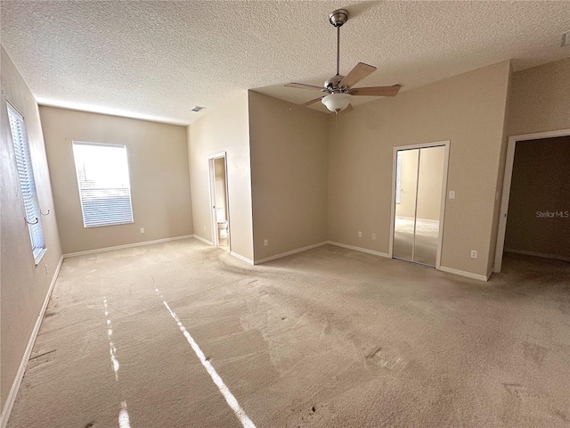 interior space featuring ceiling fan and a textured ceiling