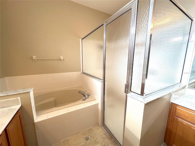 bathroom with vanity and independent shower and bath