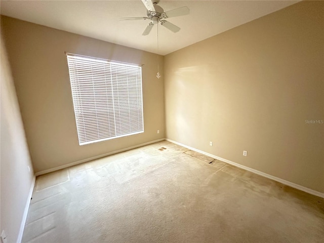 carpeted spare room with ceiling fan