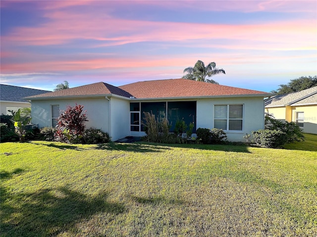 ranch-style house featuring a yard