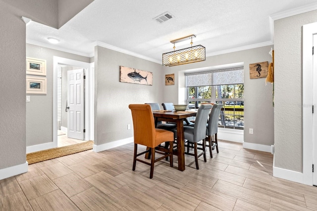 dining room featuring a textured ceiling and ornamental molding