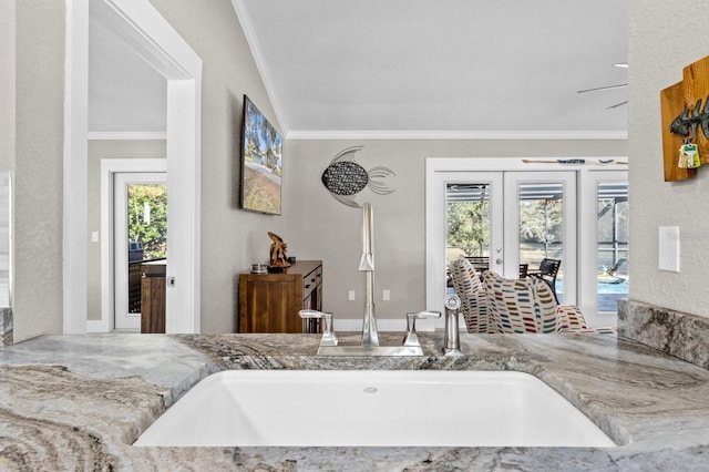 interior space with plenty of natural light, ornamental molding, and french doors