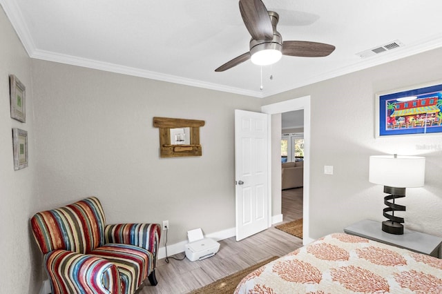 bedroom featuring light hardwood / wood-style flooring, ceiling fan, and crown molding