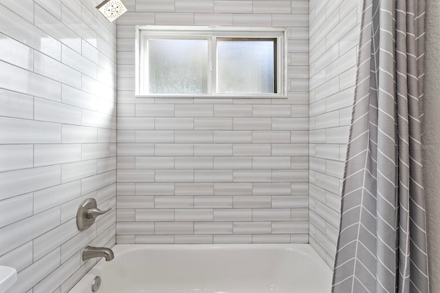 bathroom featuring shower / bathtub combination with curtain