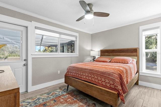 bedroom with ceiling fan, ornamental molding, and multiple windows