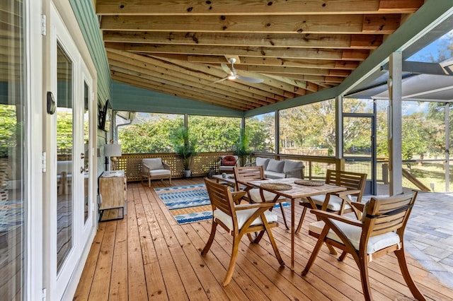 sunroom / solarium featuring vaulted ceiling