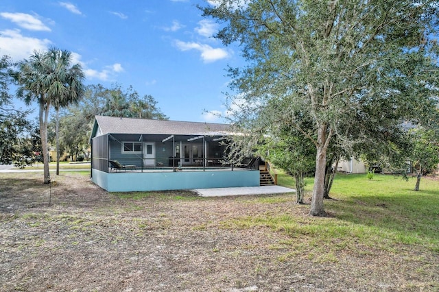 rear view of property featuring a yard