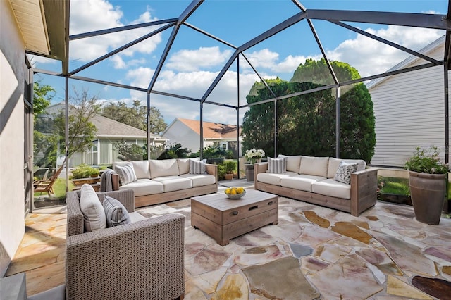 view of patio featuring outdoor lounge area and glass enclosure