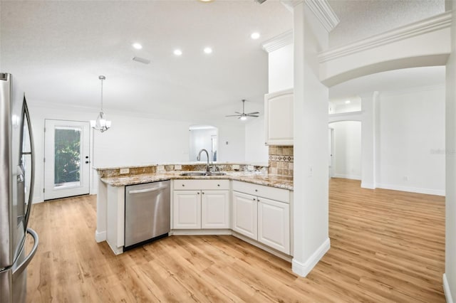 kitchen with white cabinets, sink, appliances with stainless steel finishes, light hardwood / wood-style floors, and kitchen peninsula