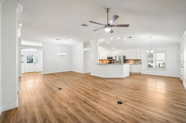 unfurnished living room featuring a textured ceiling, ceiling fan with notable chandelier, crown molding, and light hardwood / wood-style flooring