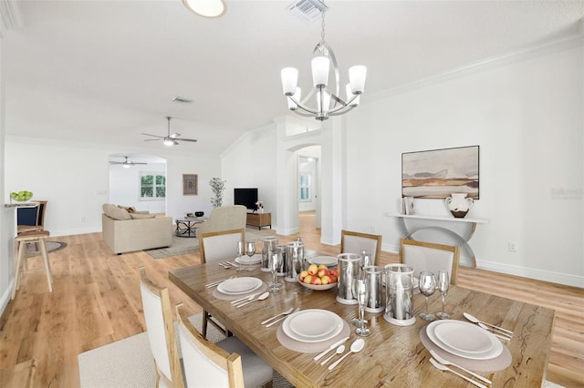 dining area featuring crown molding, light hardwood / wood-style flooring, and ceiling fan with notable chandelier