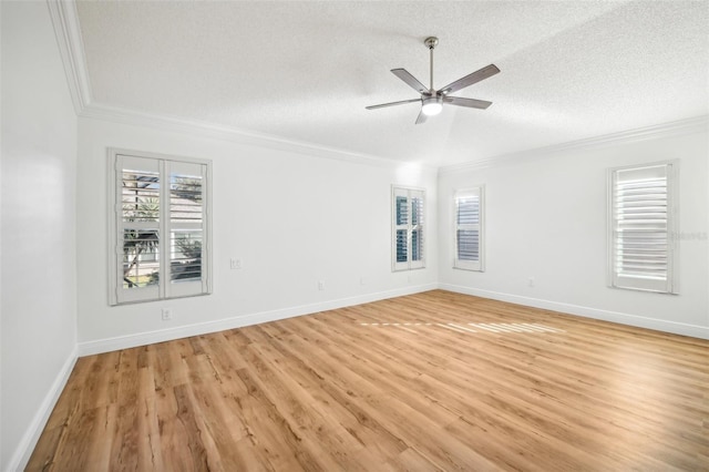 spare room featuring crown molding, ceiling fan, a textured ceiling, and light wood-type flooring