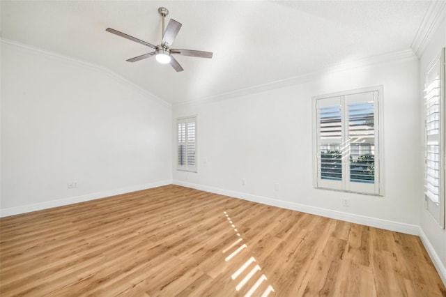 spare room featuring ceiling fan, light hardwood / wood-style floors, lofted ceiling, and ornamental molding