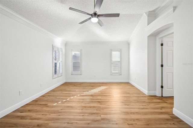 unfurnished room featuring crown molding, ceiling fan, a textured ceiling, and light wood-type flooring