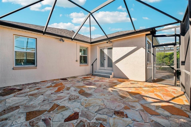 exterior space with glass enclosure and a patio area