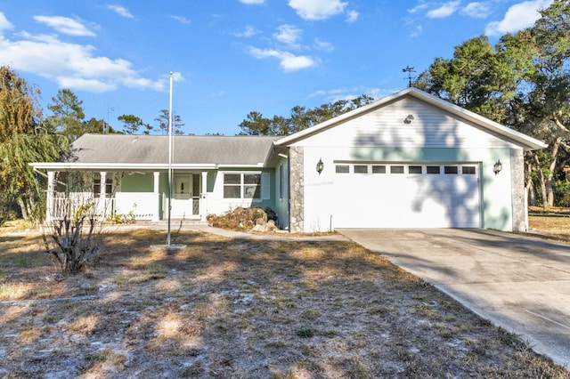 ranch-style house featuring covered porch and a garage