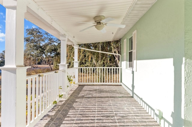 wooden deck featuring ceiling fan and covered porch