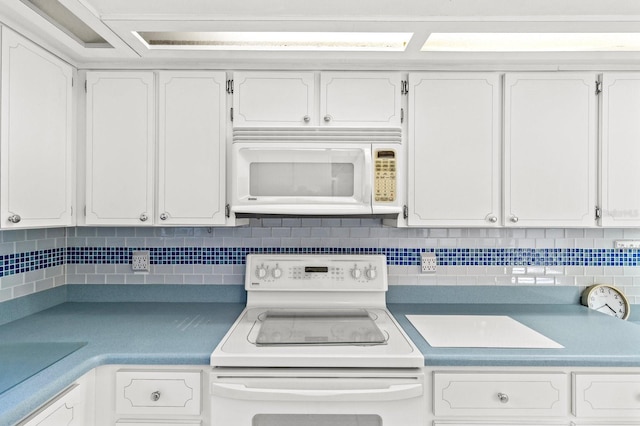 kitchen with white cabinetry, white appliances, and tasteful backsplash