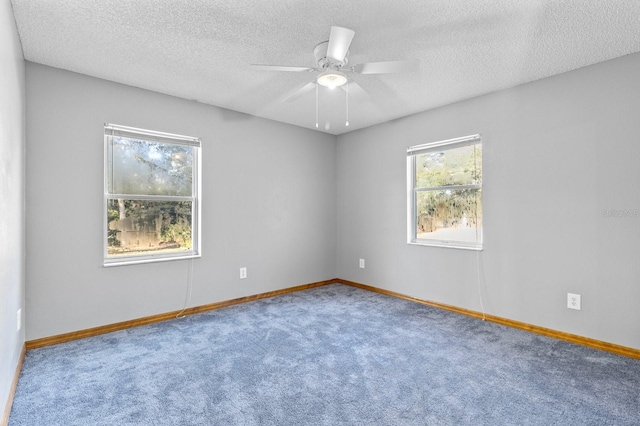 unfurnished room with ceiling fan, carpet, and a textured ceiling