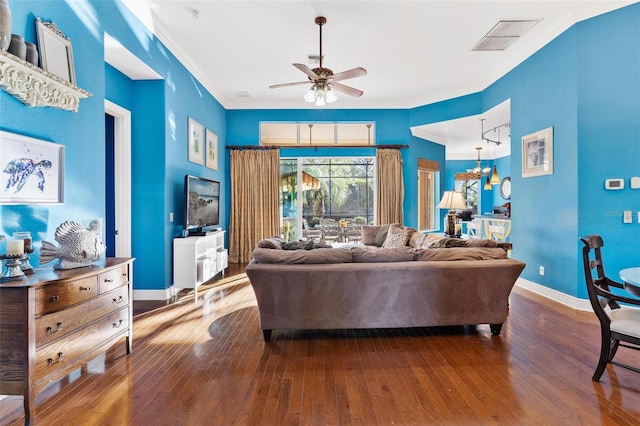 living room with hardwood / wood-style floors, ceiling fan, and crown molding