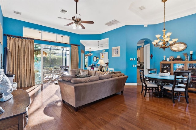 living room with wood-type flooring, ceiling fan with notable chandelier, and crown molding