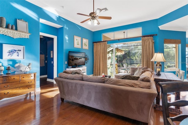 living room featuring ceiling fan, crown molding, and dark wood-type flooring