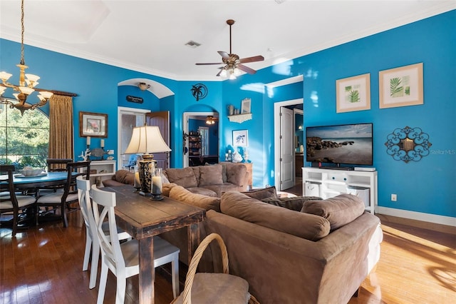 living room with hardwood / wood-style floors, ceiling fan with notable chandelier, and ornamental molding