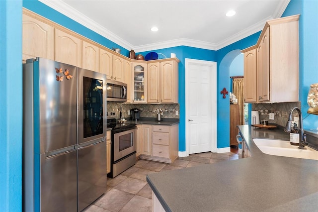 kitchen featuring sink, stainless steel appliances, backsplash, crown molding, and light brown cabinetry