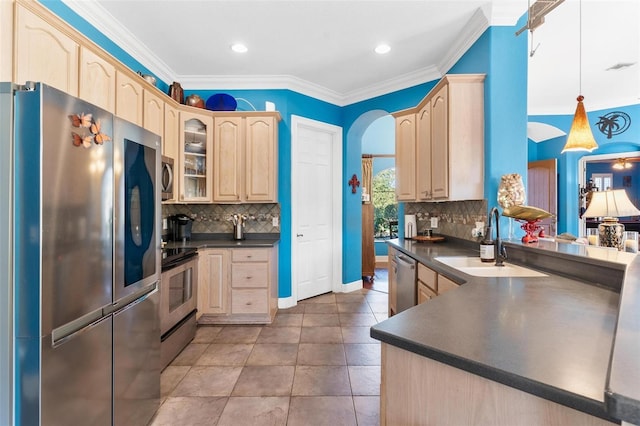 kitchen with ornamental molding, stainless steel appliances, sink, light brown cabinets, and pendant lighting