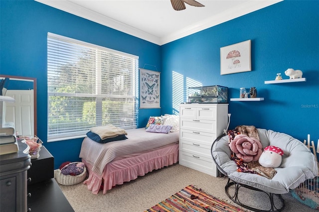 bedroom featuring ceiling fan, crown molding, and carpet floors