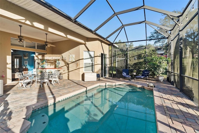 view of pool featuring a lanai, a patio area, and ceiling fan