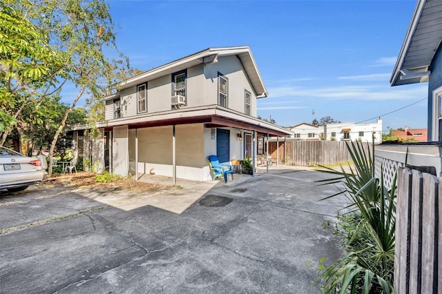 rear view of property with a garage