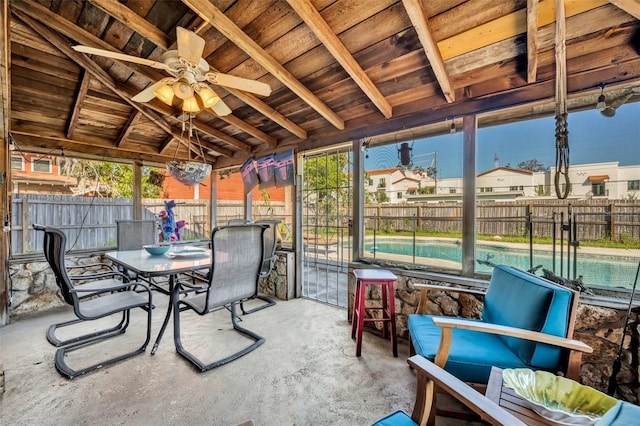 sunroom / solarium featuring lofted ceiling with beams and ceiling fan